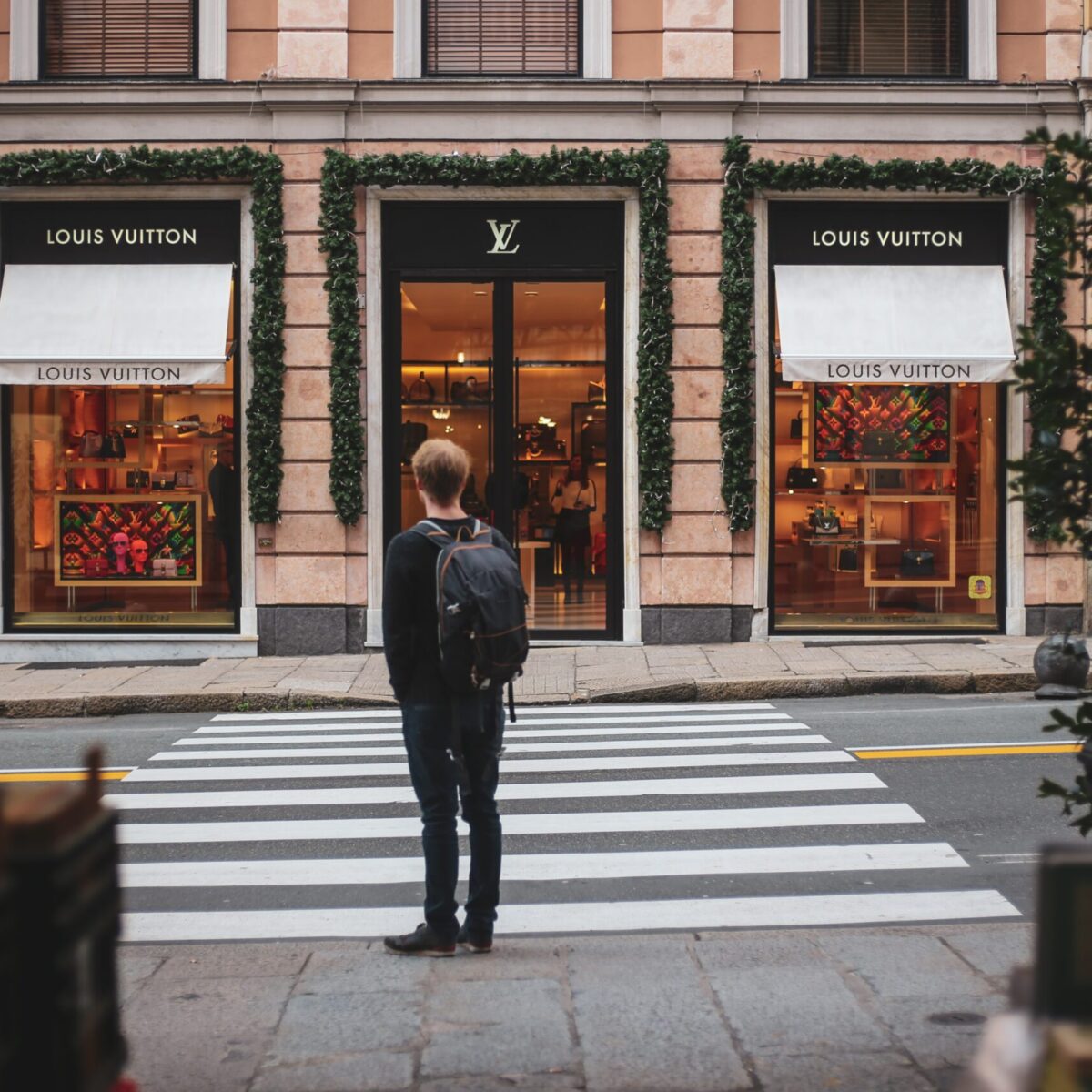 a man in front of louis vuitton store russian translations for luxury brands